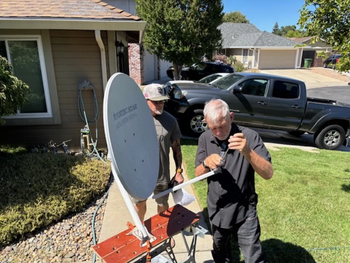 Team testing satellite hardware outside