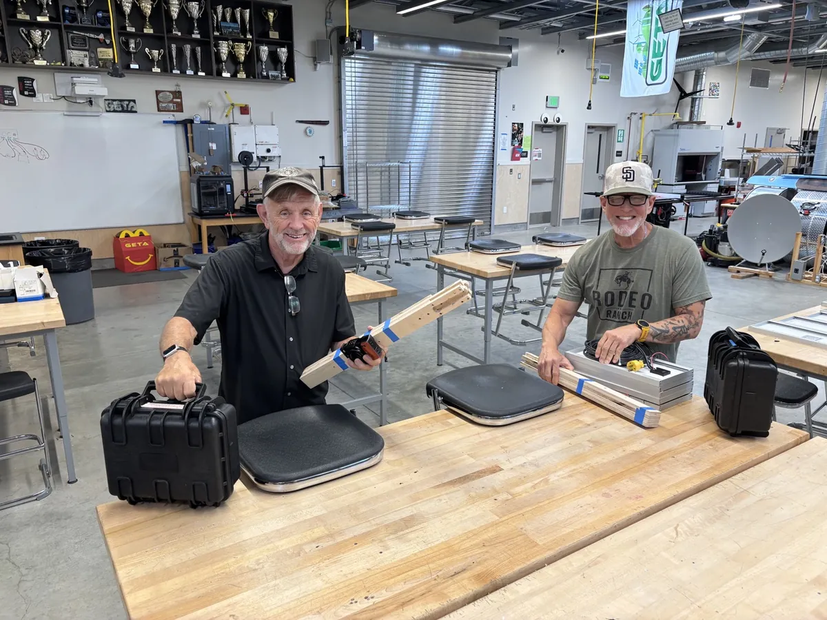 Team assembling field kit components in a workshop